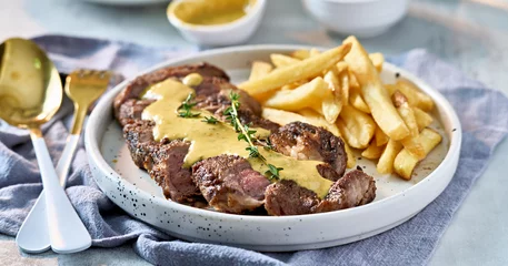  sliced beef steak with sauce and french fries © Joshua Resnick