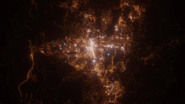 Reno (Nevada, USA) aerial view at night. Top view on city from space. Camera is zooming in, rotating clockwise