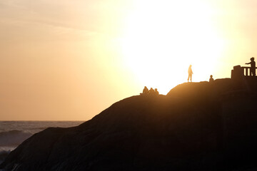 Silhouette of people on the rocks