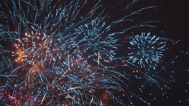 Beautiful firework in dark sky. The colors are red, blue and orange