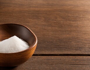 sea salt in a wooden spoon on a brown background