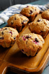 Homemade blueberry muffins on a wooden serving tray. Close-up. 