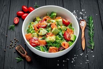 Salad with salmon, salad mix, parmesan, orange, avocado, tomatoes