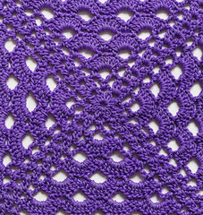 Crochet purple granny square background. Handmade knitted texture.