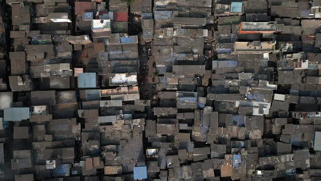 Top down aerial view descending over the Dharavi slums in Mumbai, Maharashtra, India. Dharavi is considered to be one of the largest slums in the world and the largest in Asia.	