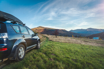 car for traveling with a mountain road © nickolya