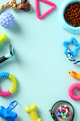 Frame of pet toys and dog grooming supplies on blue background. Flat lay, top view
