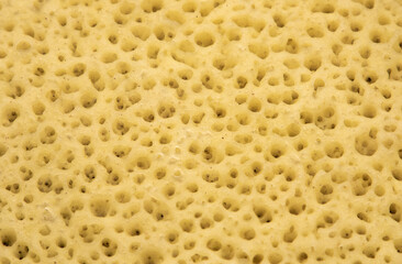 a close-up with the texture of a cheese with many holes