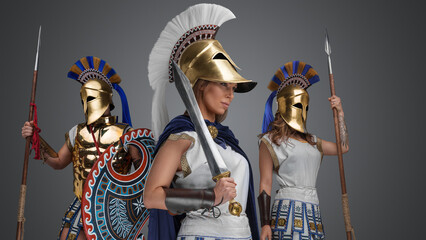 Obraz premium Studio shot of isolated on grey background greek female warriors with plumed helmets.
