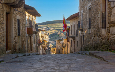  Sloping street view with old stone buildings in Puebla de Sanabria, Zamora, Spain