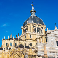 Cupula and annexed constructions of the Almudena Cathedral on its back in the city of Madrid, Spain.
