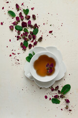 Obraz na płótnie Canvas cup of tea, damask rose, pink tea, close-up,