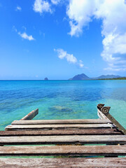 Pier at beach in Landscape of the French West Indies. The wooden bridge stretches into the sea....