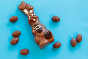 Easter chocolate bunny and chocolate eggs on blue background