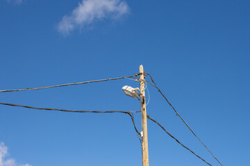 Street lamp and cables, blue sky background