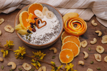 Fototapeta premium Bowl with Greek yogurt and fruit with nuts, seeds