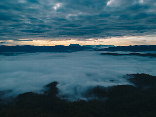 Mountain range and mist with sky and sunrise and surrounding area.