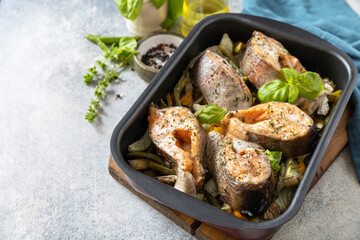 Healthy baked fish salmon steaks with basil, green beans, sweet peppers and onions. Cooking a delicious low carb dinner, healthy nutrition concept, diet menu. Copy space.