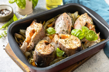 Seafood. Recipe. Healthy baked fish salmon steaks with basil, green beans, sweet peppers and onions. Cooking a delicious low carb dinner, healthy nutrition concept, diet menu.