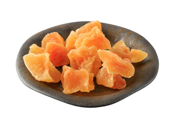 Candied melon pieces with sugar in dark vintage plate closeup isolated on white background.