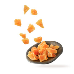 Candied melon pieces with sugar flying and falling on vintage plate isolated on white background.