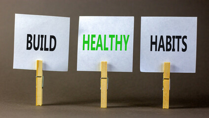 Motivation and Build healthy habits symbol. Concept words Build healthy habits on white paper on a beautiful grey table grey background. Business build healthy habits concept. Copy space.