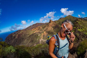 Female hiker hiking the beautiful cliffs of Los Gigantes in Tenerife Canary Islands in Spain