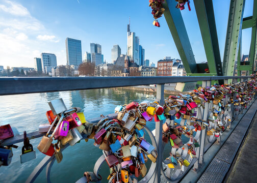 Love Locks at Eiserner Steg (Iron Footbridge) at River Main and skyscrapers skyline - Frankfurt, Germany