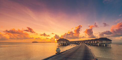 Happy child toddler jumping into infinity swimming pool at sunset as travel lifestyle portrait. Cute girl with blond hair snorkel googles jumps into water splashes water drops. Family summer vacation