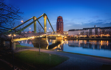 Flosserbrucke Bridge, Main Plaza Building and River Main at night - Frankfurt, Germany