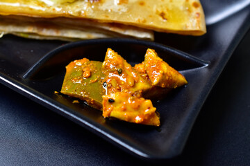 Closeup of Mango pickle slices on food plate, aam ka aachar 