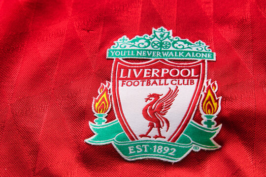 Liverpool FC club emblem on red soccer shirt.