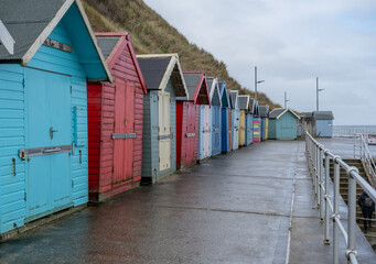Colourful beach huts along the promenade in the seaside town of Sheringham on the North Norfolk coast