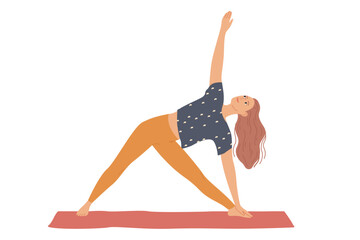 Woman performs yoga exercises by bending to the side and raising her hand - a triangle pose, three corners or Trikonasana.