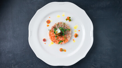 Salmon and sea bream tartare with microgreens and capers.