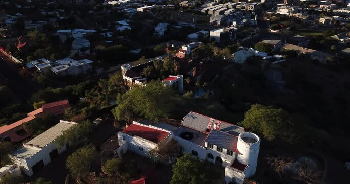 4K high quality aerial video drone footage of green hills and posh residential historical area with houses and old mansions on sunny afternoon in Windhoek, Namibia in southern Africa