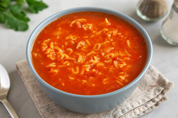 Homemade Alphabet Soup in Tomato Sauce in a Bowl, side view.