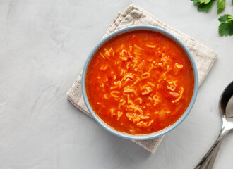 Homemade Alphabet Soup in Tomato Sauce in a Bowl, top view. Overhead, from above, flat lay.
