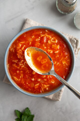 Homemade Alphabet Soup in Tomato Sauce in a Bowl, top view. Overhead, from above, flat lay. Close-up.