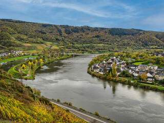 Fototapeta na wymiar Senhals and Senheim on either side of the Moselle river with lush mountain in the background in Cochem-Zell district, Germany