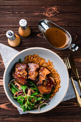 Pork fillet with mushroom salad, green beans, red onion, herbs and sauce.