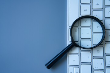 In Search of SEO Success. Magnifying glass and keyboard.