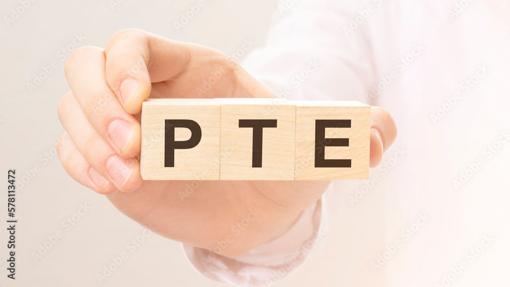 Poster wooden cubes with the letters pte on the hand on the white background. qa is short for question and 