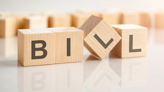 text BIIL on wooden blocks, background have blur effect