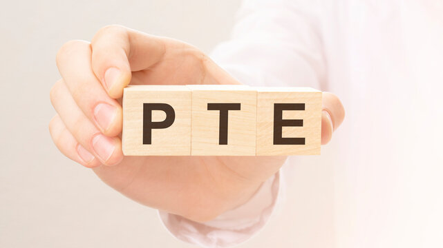 wooden cubes with the letters PTE on the hand on the white background. qa is short for question and answer.