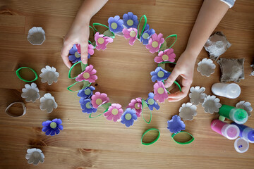 DIY project with kids, an egg carton is transformed into Easter flower wreath. Creativity and...