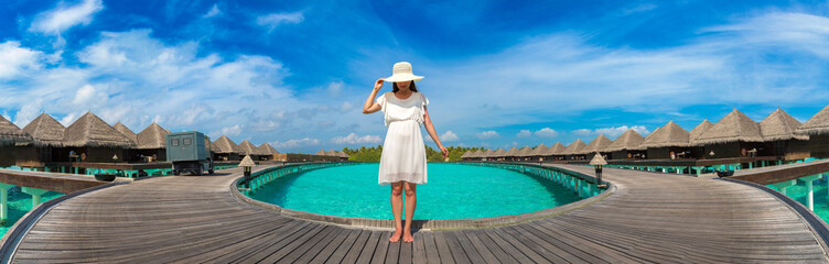Fototapeta premium Woman standing on the wooden pier
