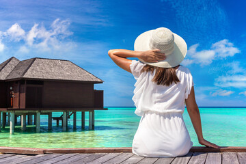 Woman sitting on the wooden pier