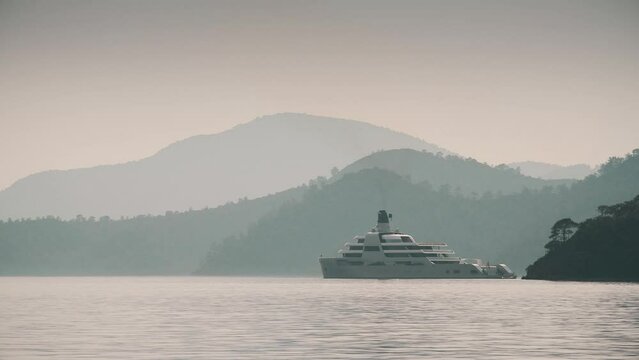 Luxury motor yacht offshore mountainous coast