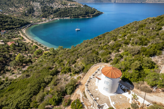 Traditional Greek windmill and Paralia Dexia bayon Ithaca island, Greece
